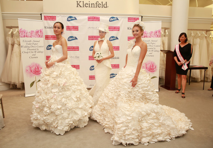 High-profile wedding planner and host of ÒMikie Saves the DateÓ, Michael Russo, poses with the winning dresses of the 11th Annual Toilet Paper Wedding Dress Contest presented by Cheap Chic Weddings and Charmin on Wednesday, June 17, 2015 in New York. (Amy Sussman/AP Images for Charmin)