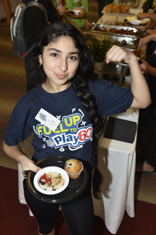 2015 Summit Latino girl healthy eating showing muscle